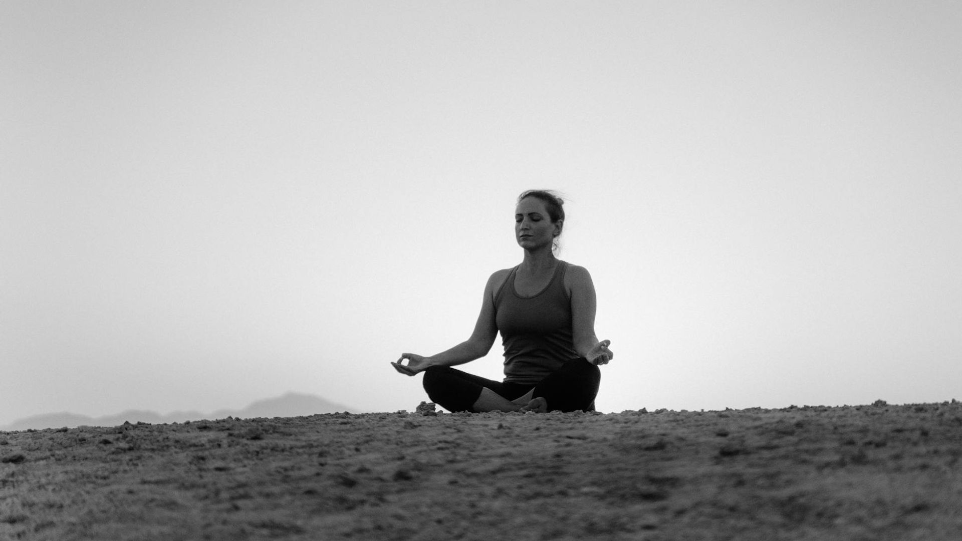 Atmospheric photo of a minimalist yoga studio at dawn.