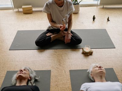 Close up of a wooden yoga block and incense.